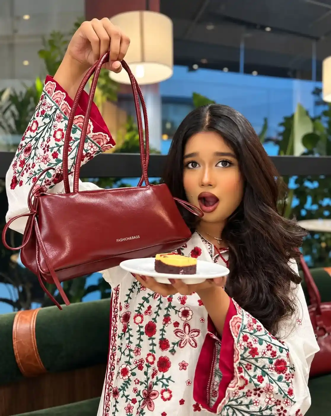 Girl holding a burgundy Korean bowknot soft leather shoulder bag